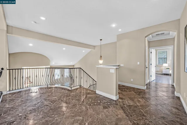 a view of a dining room and livingroom with furniture wooden floor a chandelier