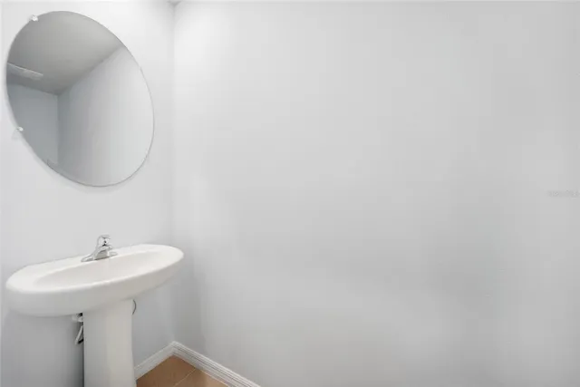 a bathroom with a sink and mirror