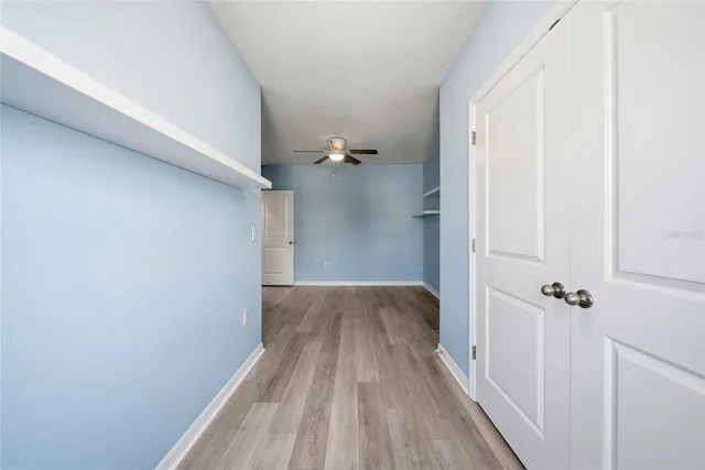 a view of a room with wooden floor and a hallway