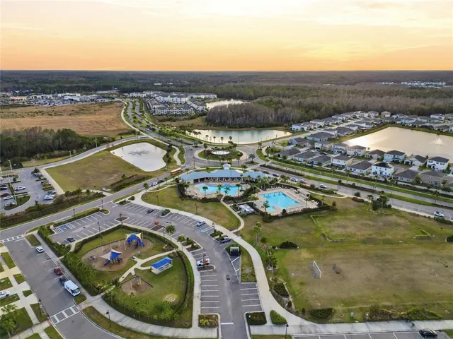 an aerial view of residential houses with outdoor space