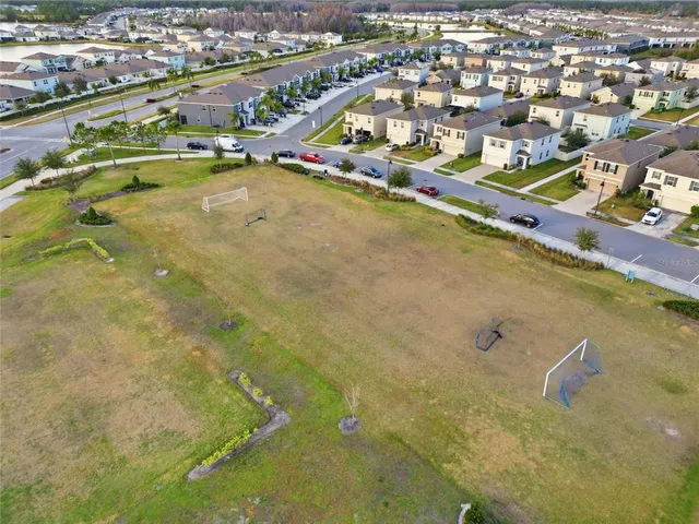 an aerial view of residential houses with outdoor space