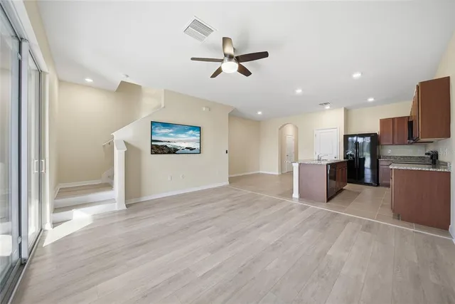 a view of a kitchen with a sink and a refrigerator