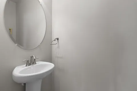 a bathroom with a sink a mirror and vanity