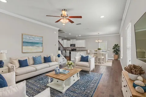 a living room with furniture and kitchen view