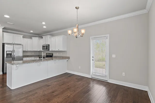 a kitchen with granite countertop a sink and steel appliances