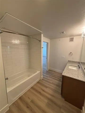 a bathroom with a granite countertop sink a toilet and shower