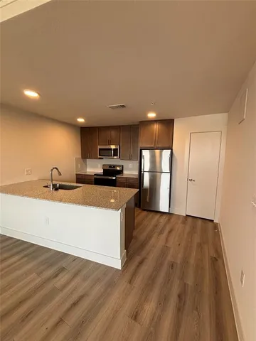 a view of kitchen with wooden floor