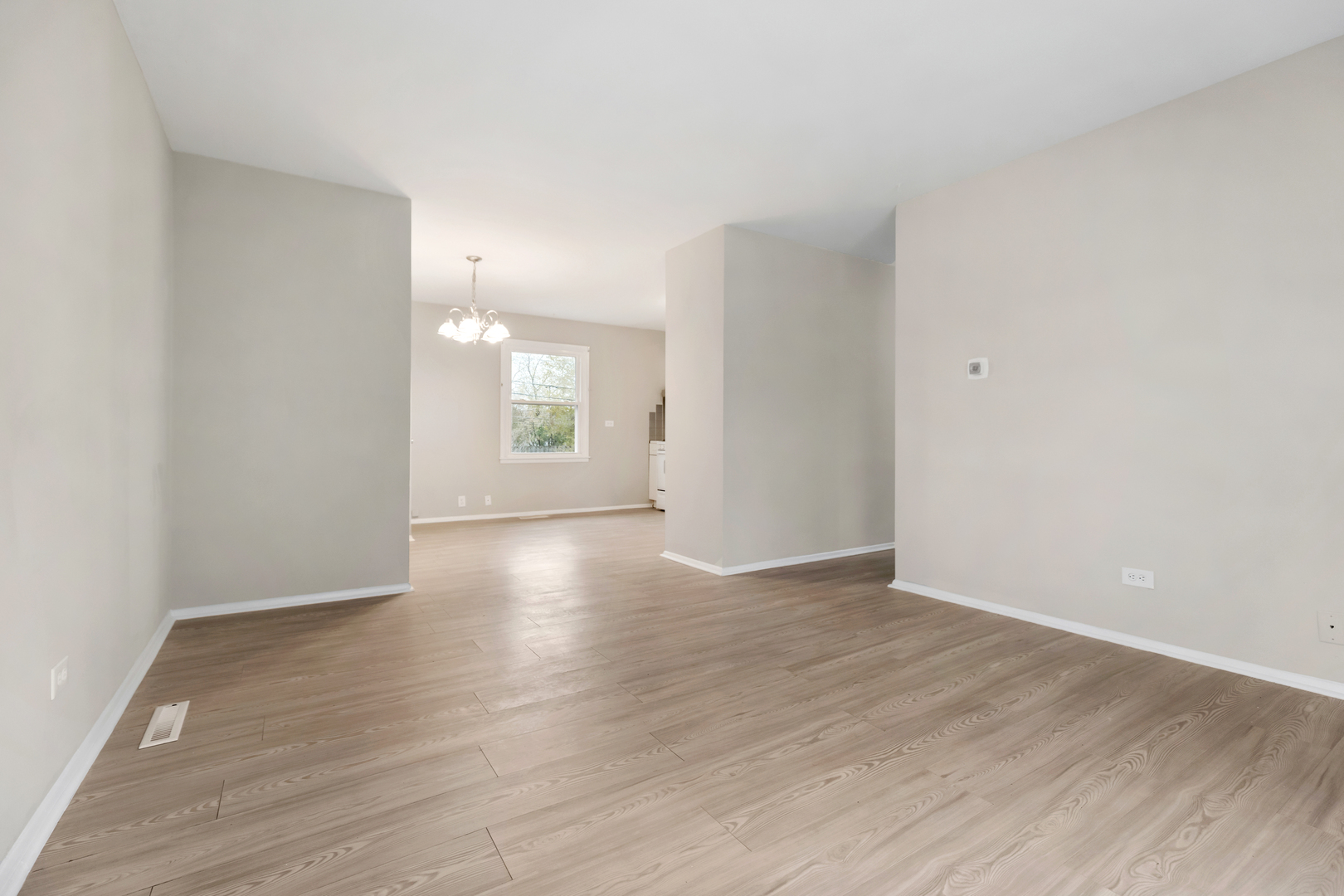 6971 Hanover Street Hanover Park, IL 60133 - Photo 5 of 20 a view of an empty room with window and wooden floor