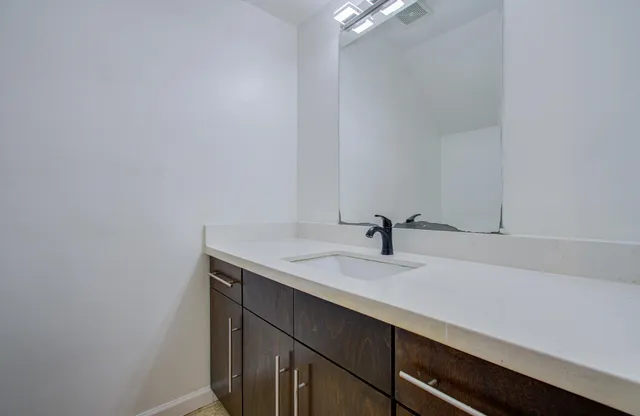 a bathroom with a sink and a mirror