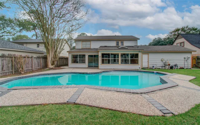 a view of house with a yard and plants