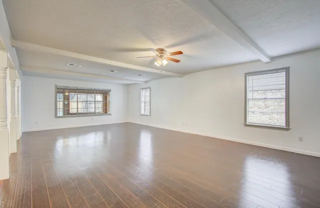 wooden floor in an empty room with a window