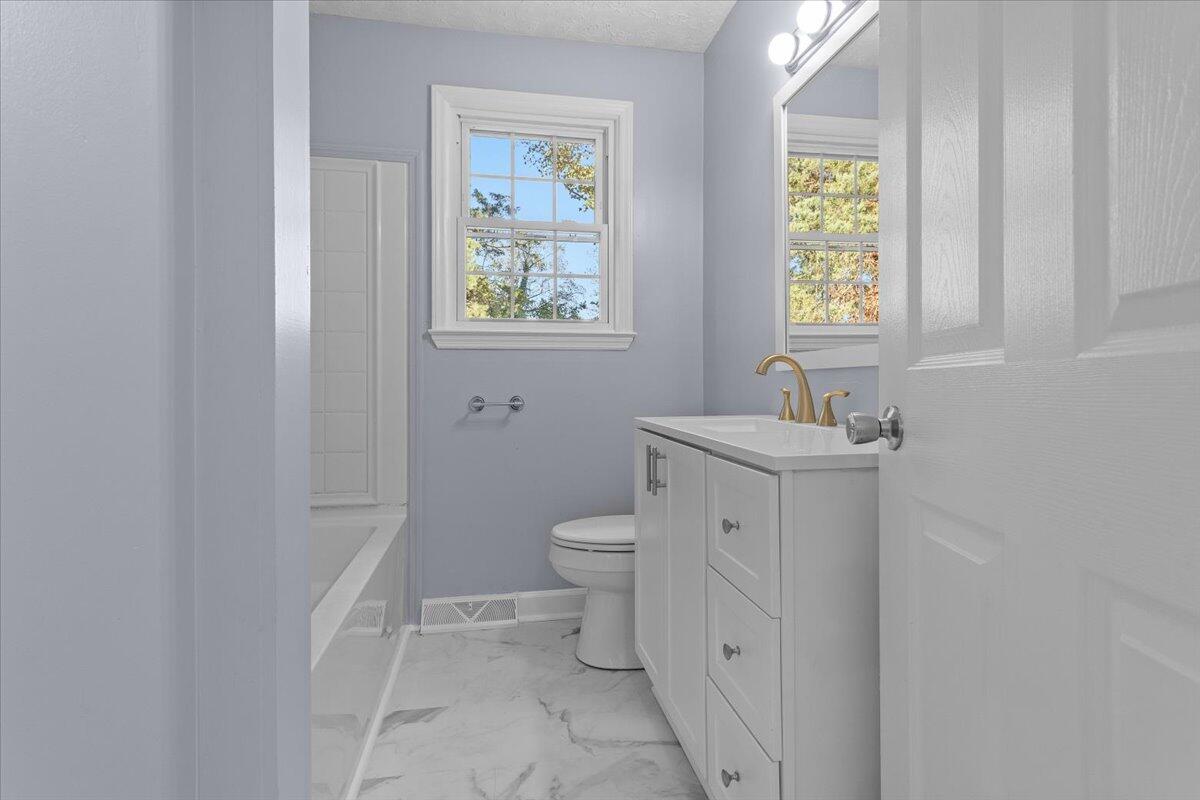 2617 Radford Road Northeast Roanoke, VA 24012 - Photo 15 of 25 a bathroom with a toilet sink and window