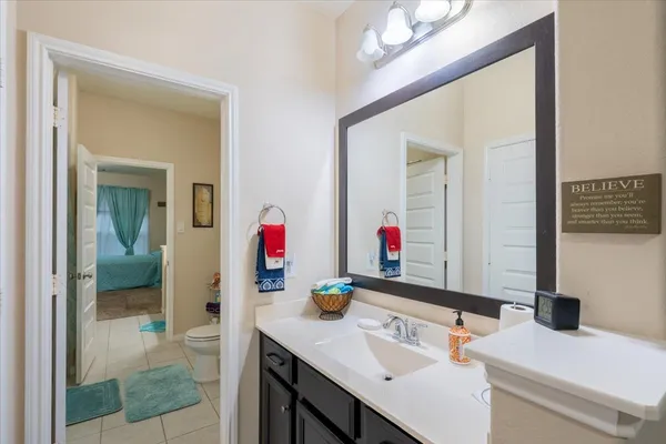 a bathroom with a sink vanity and a mirror