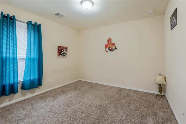 an empty room with windows and cabinet