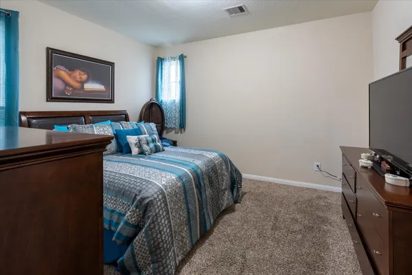 a bedroom with a bed and a dresser