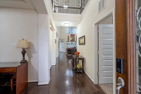 a view of a hallway with wooden floor and stairs