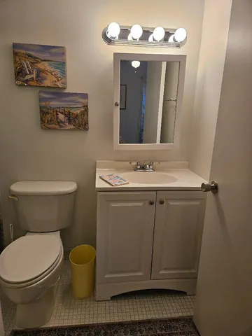 a bathroom with a sink toilet and mirror