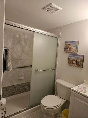a bathroom with a toilet and a shower