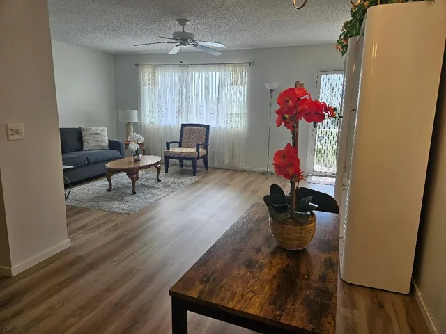 a living room with furniture and flowers