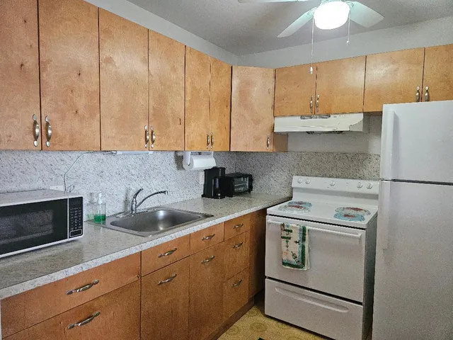 a kitchen with appliances cabinets and a sink