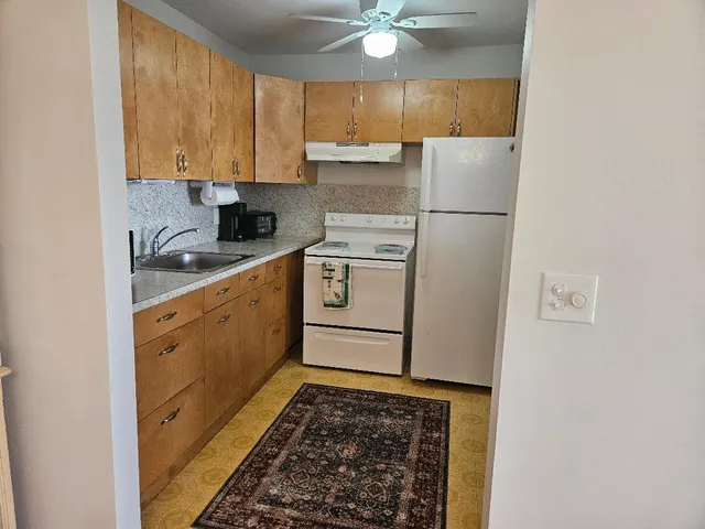 a kitchen with a refrigerator stove and sink