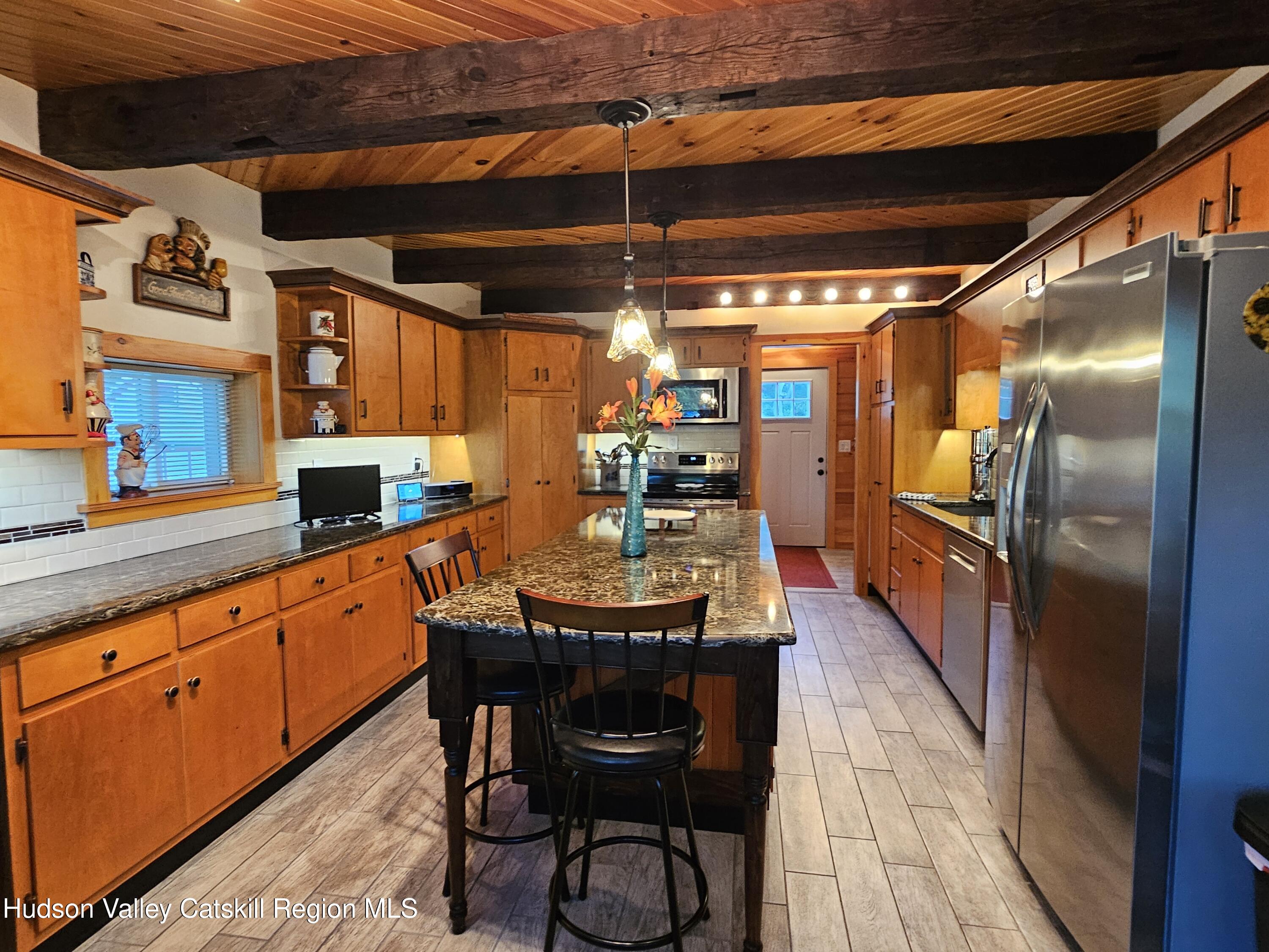 463 County Rt 46 Catskill, NY 12414 - Photo 10 of 44 a kitchen with stainless steel appliances granite countertop a sink and wooden cabinets