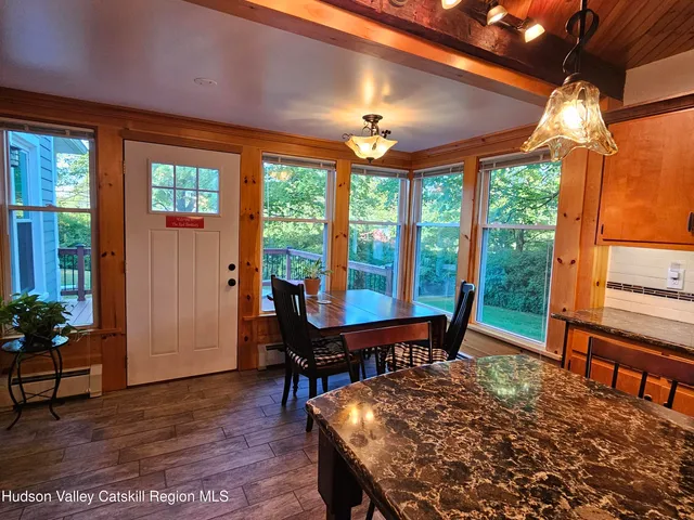 a view of balcony with wooden floor and outdoor seating