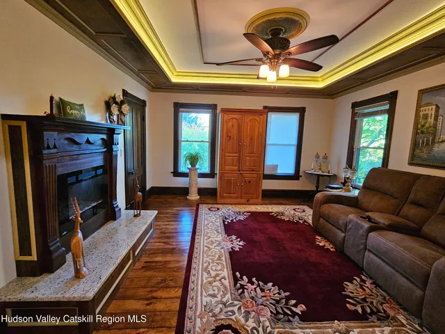 a living room with a fireplace furniture and a potted plant