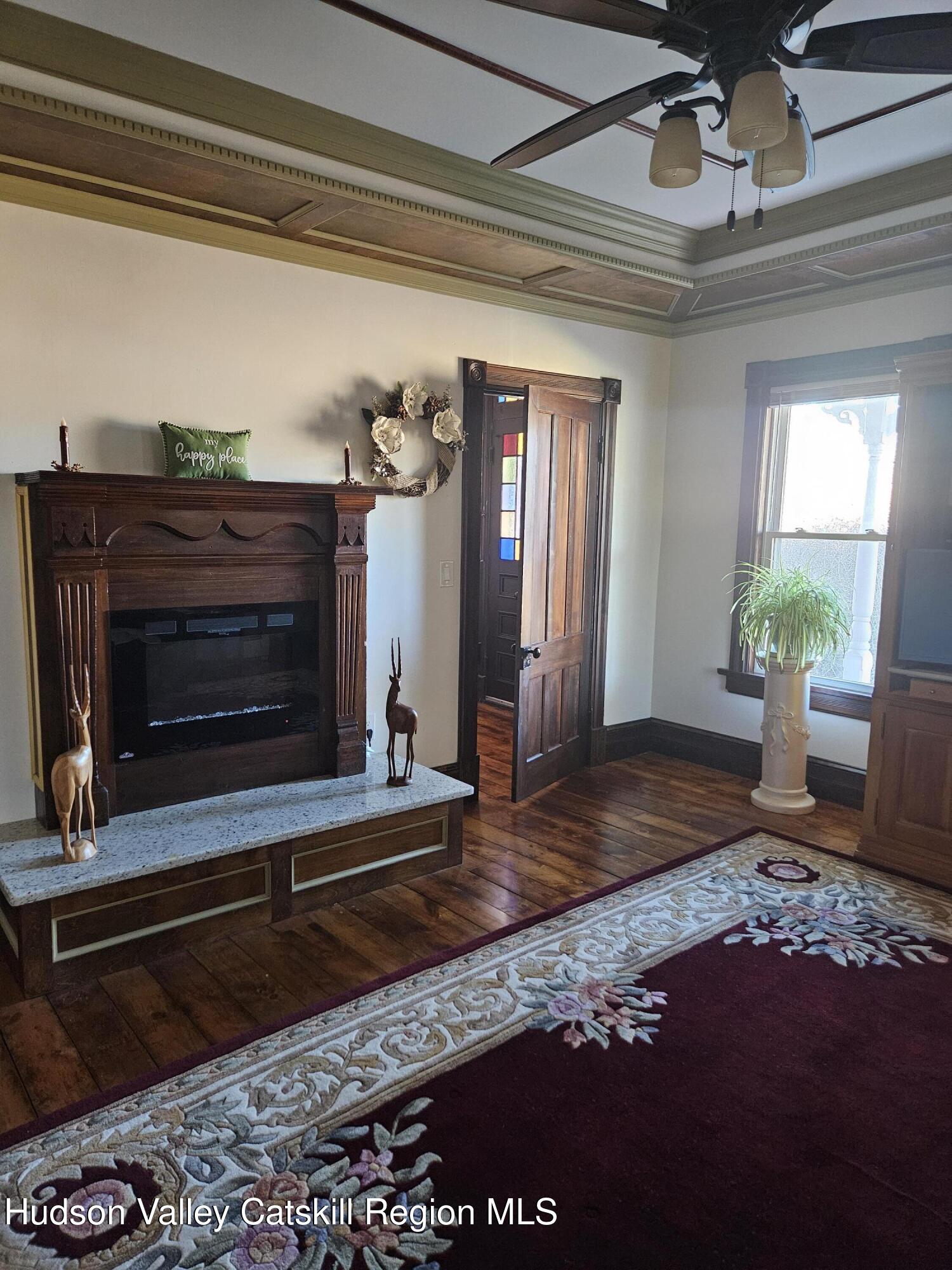 463 County Rt 46 Catskill, NY 12414 - Photo 15 of 44 a living room with a fireplace furniture and a potted plant