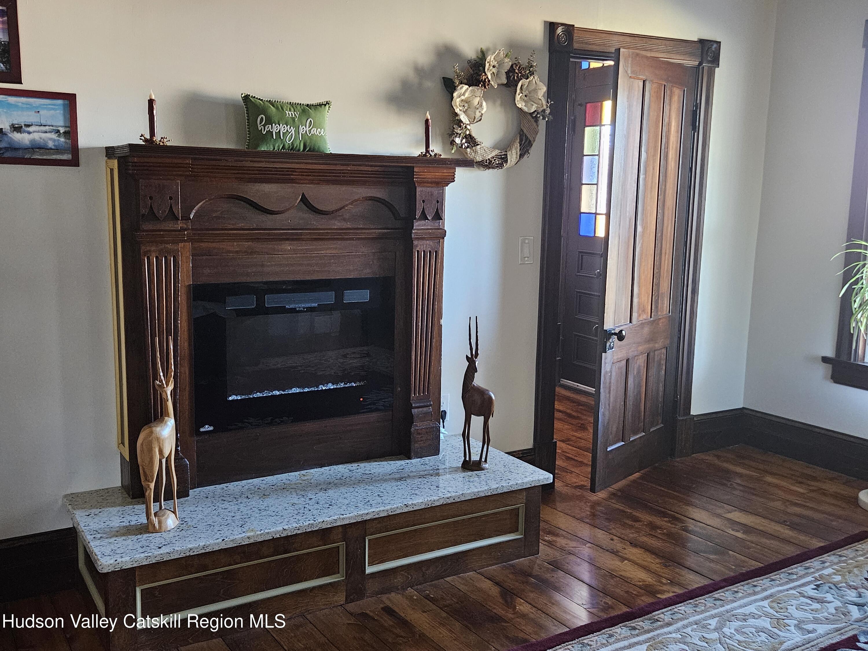 463 County Rt 46 Catskill, NY 12414 - Photo 16 of 44 a living room with a fireplace and wooden floor