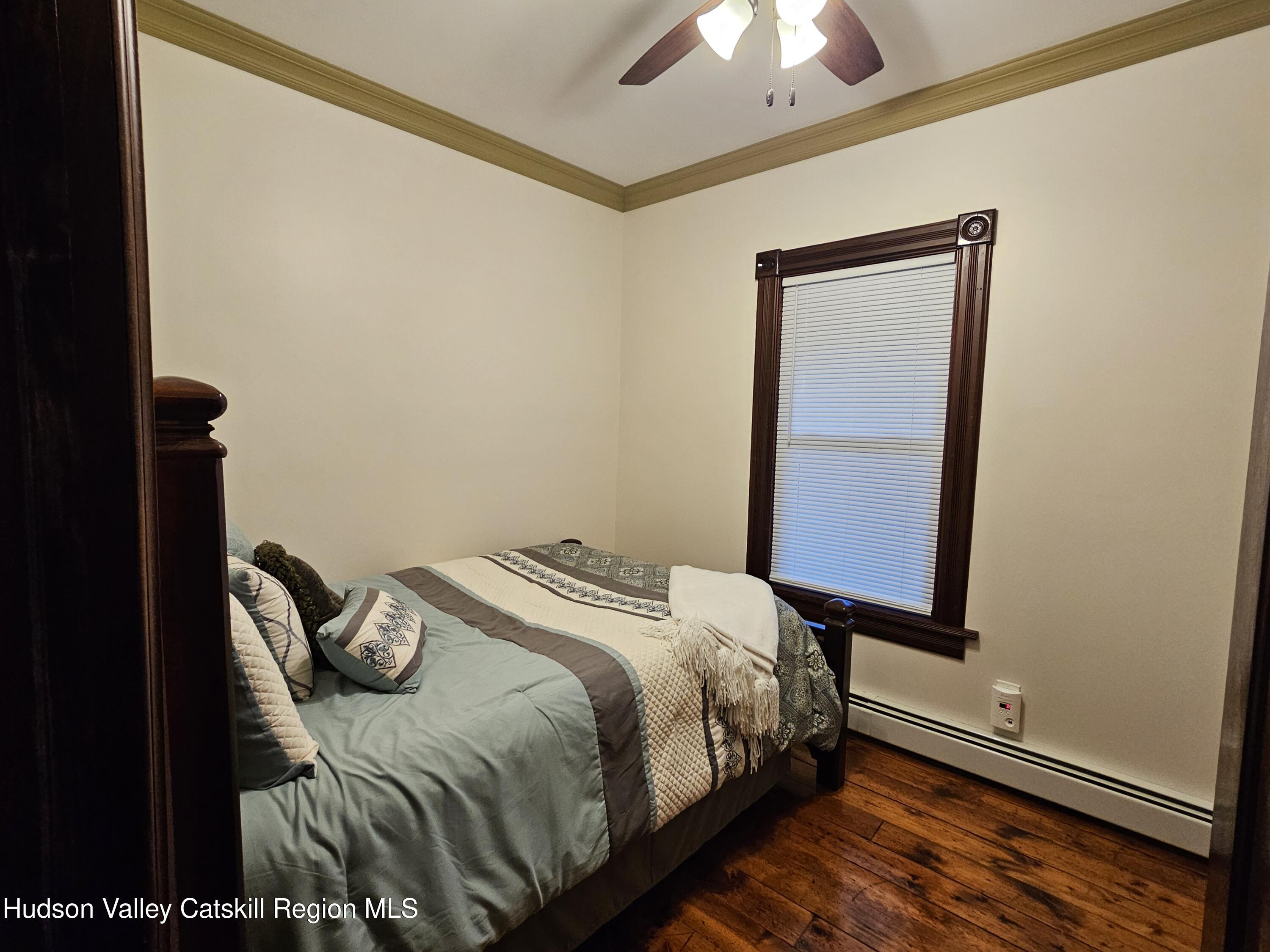 463 County Rt 46 Catskill, NY 12414 - Photo 21 of 44 a bedroom with a bed and a chandelier