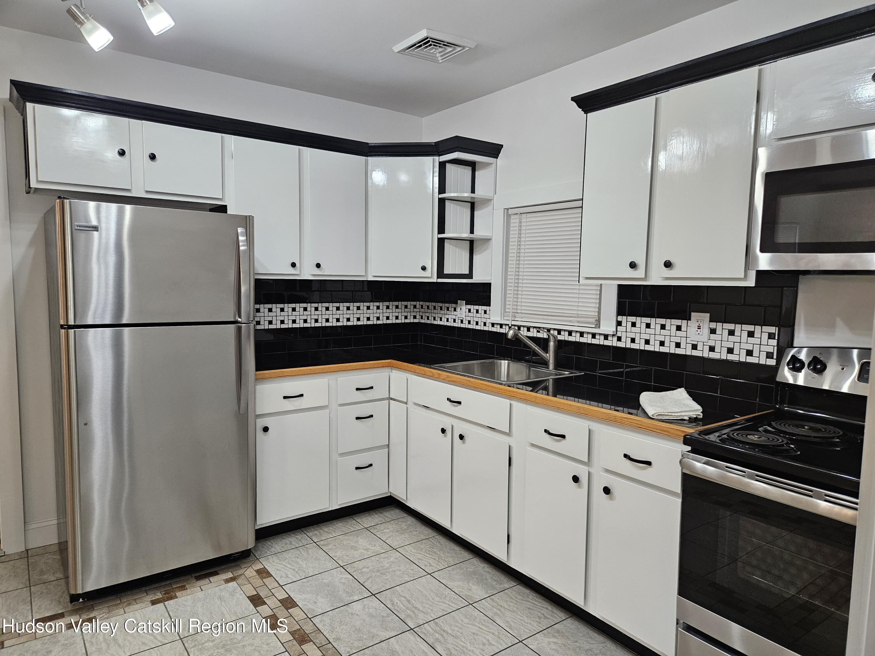 463 County Rt 46 Catskill, NY 12414 - Photo 29 of 44 a kitchen with granite countertop a refrigerator sink and stove