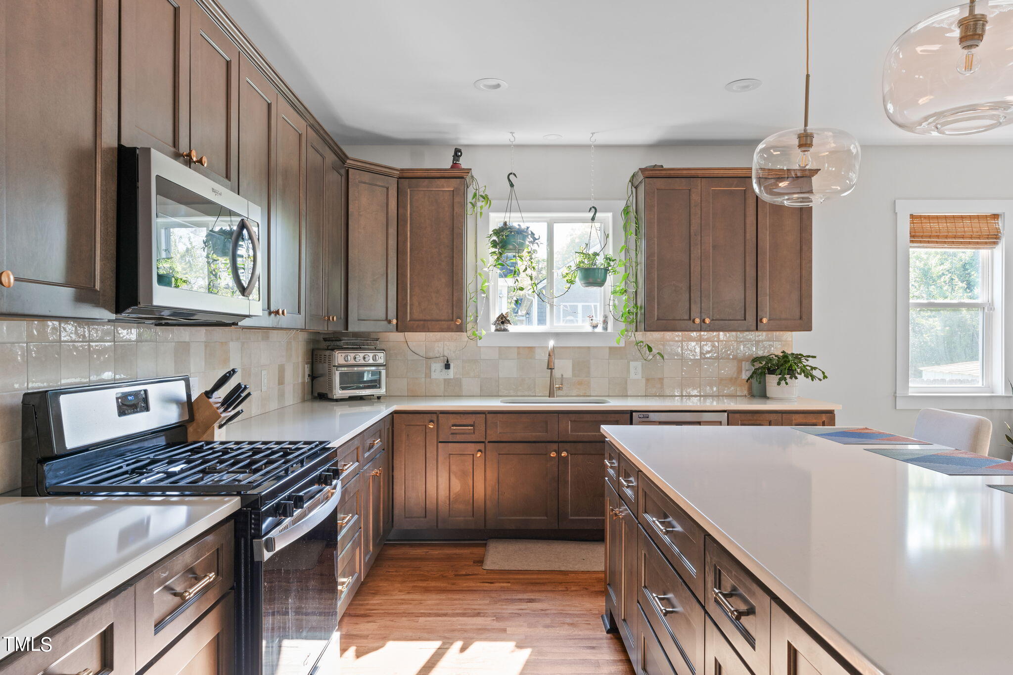 312 East Lee Street Raleigh, NC 27601 - Photo 11 of 48 a kitchen with stainless steel appliances granite countertop a sink stove and cabinets