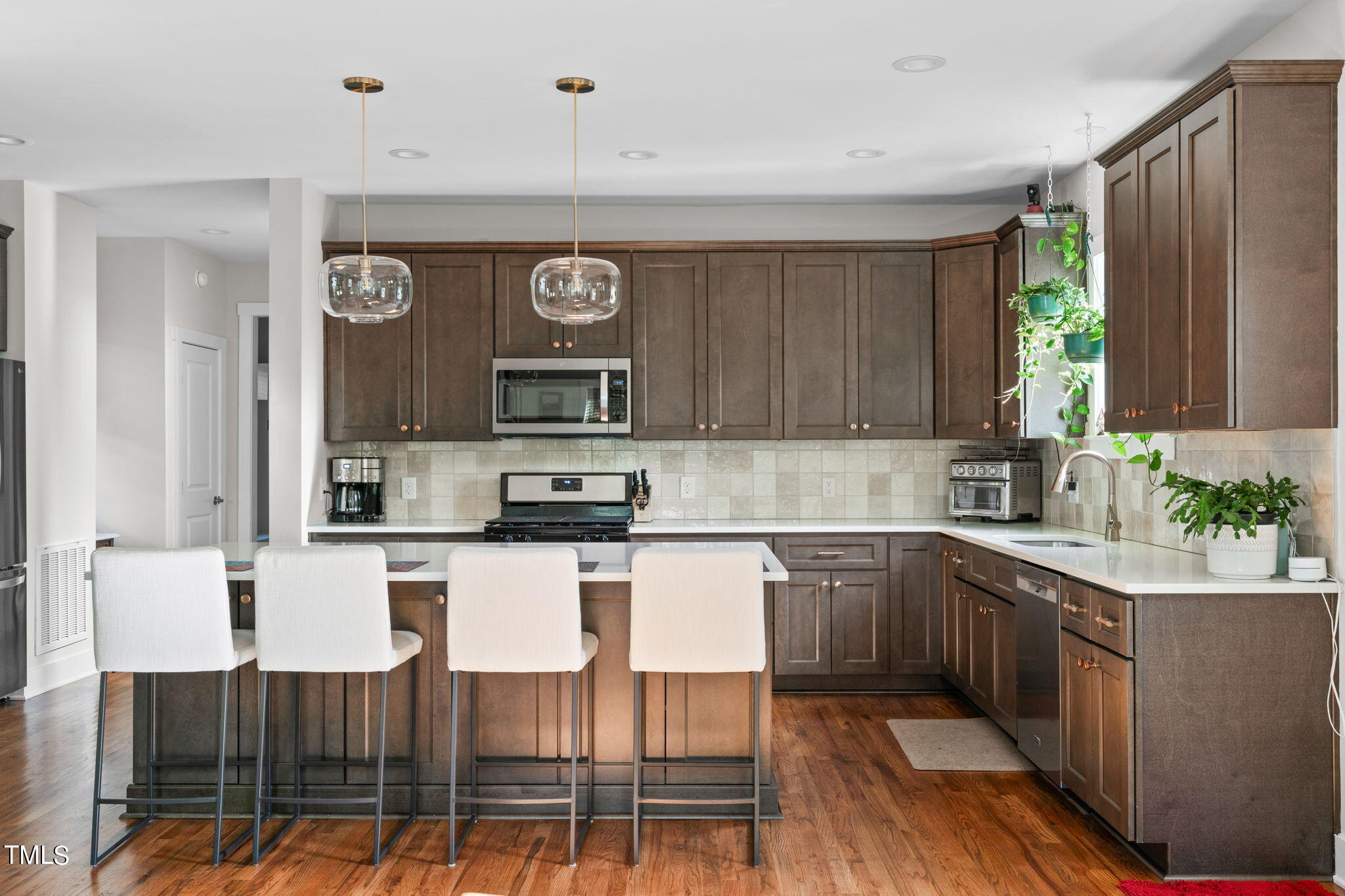 312 East Lee Street Raleigh, NC 27601 - Photo 13 of 48 a kitchen with stainless steel appliances granite countertop a stove top oven a sink and dishwasher