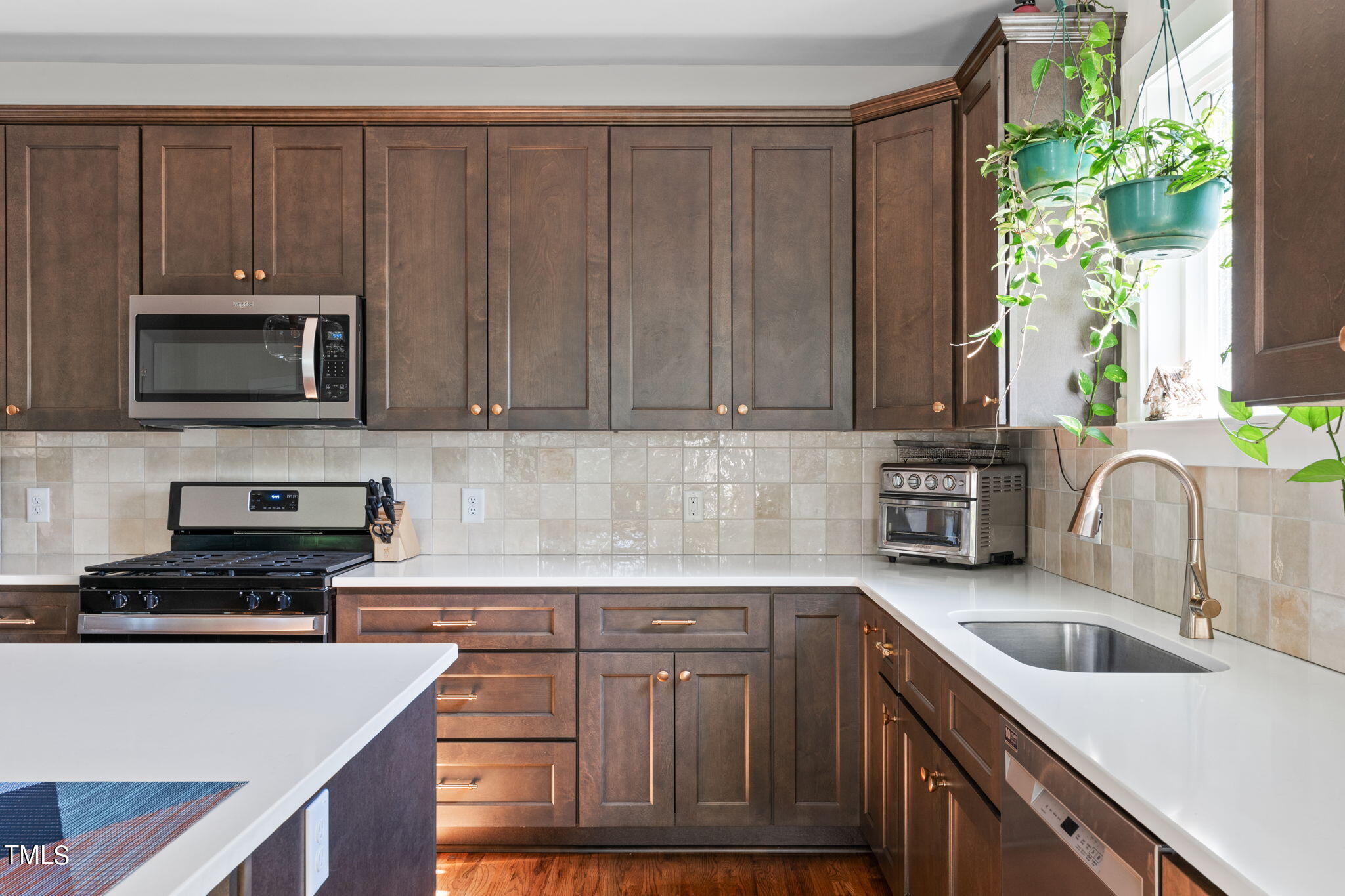 312 East Lee Street Raleigh, NC 27601 - Photo 15 of 48 a kitchen with kitchen island granite countertop a sink dishwasher stove and microwave with wooden cabinets