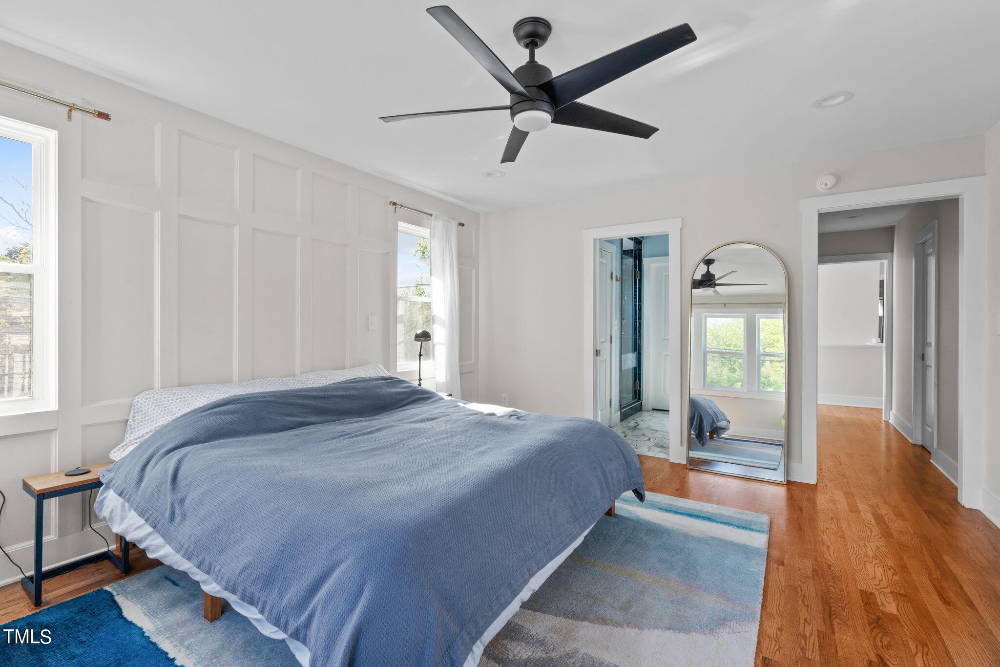 312 East Lee Street Raleigh, NC 27601 - Photo 31 of 48 a bedroom with a large bed and a chandelier