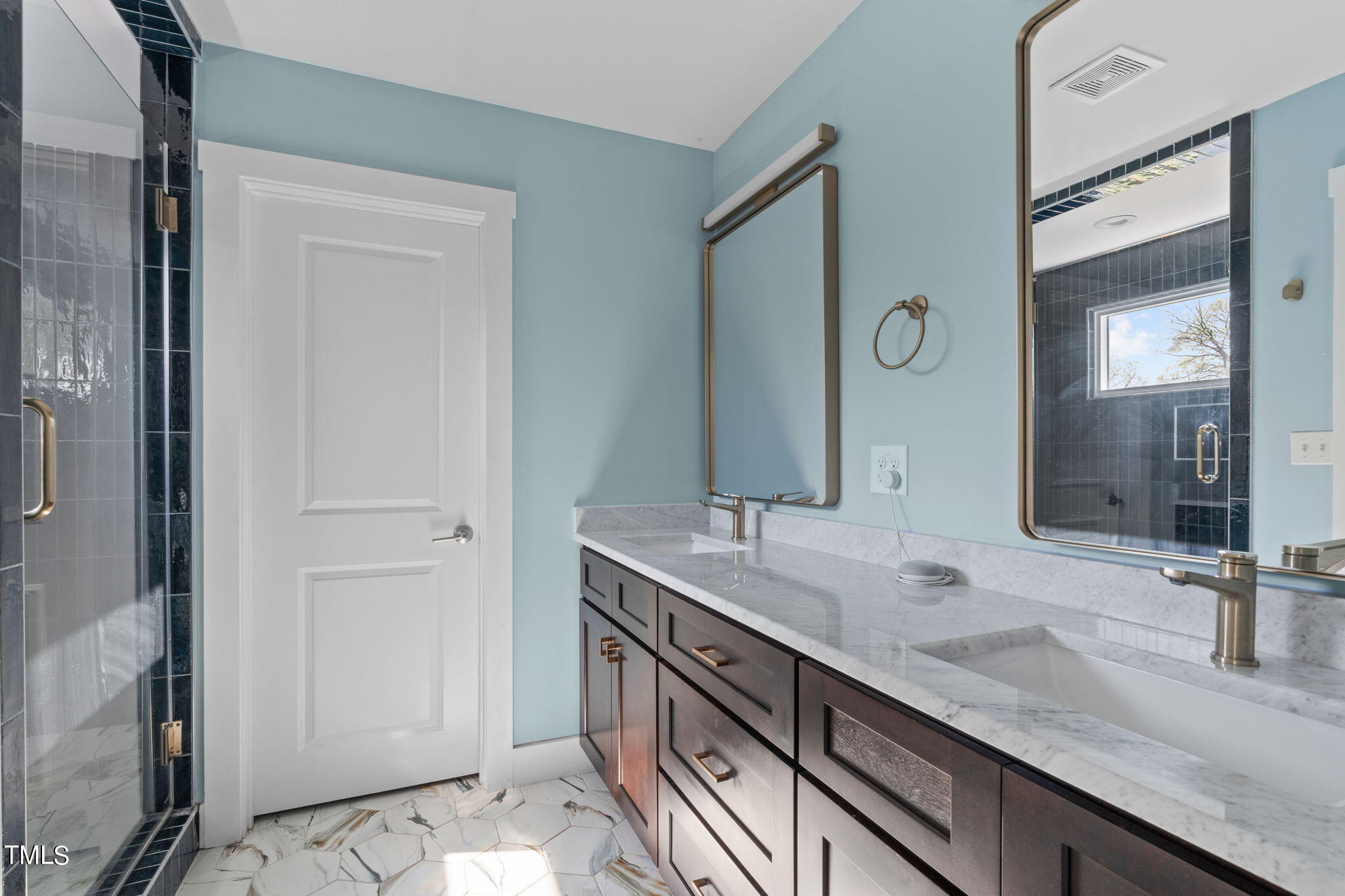 312 East Lee Street Raleigh, NC 27601 - Photo 32 of 48 a bathroom with a granite countertop sink and a mirror
