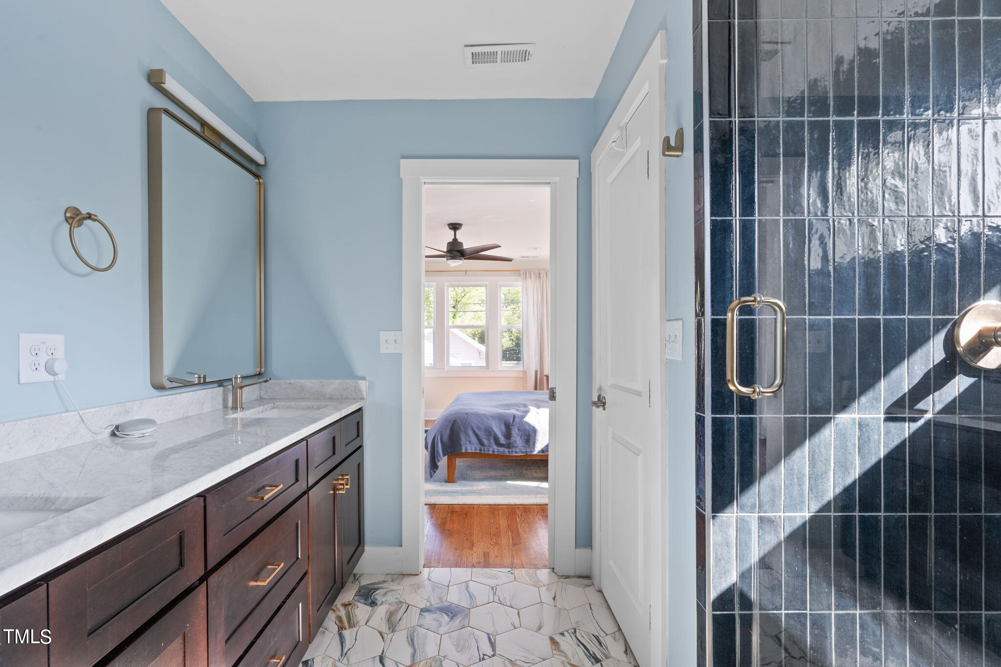 312 East Lee Street Raleigh, NC 27601 - Photo 34 of 48 a en suite bathroom with a sink and a mirror