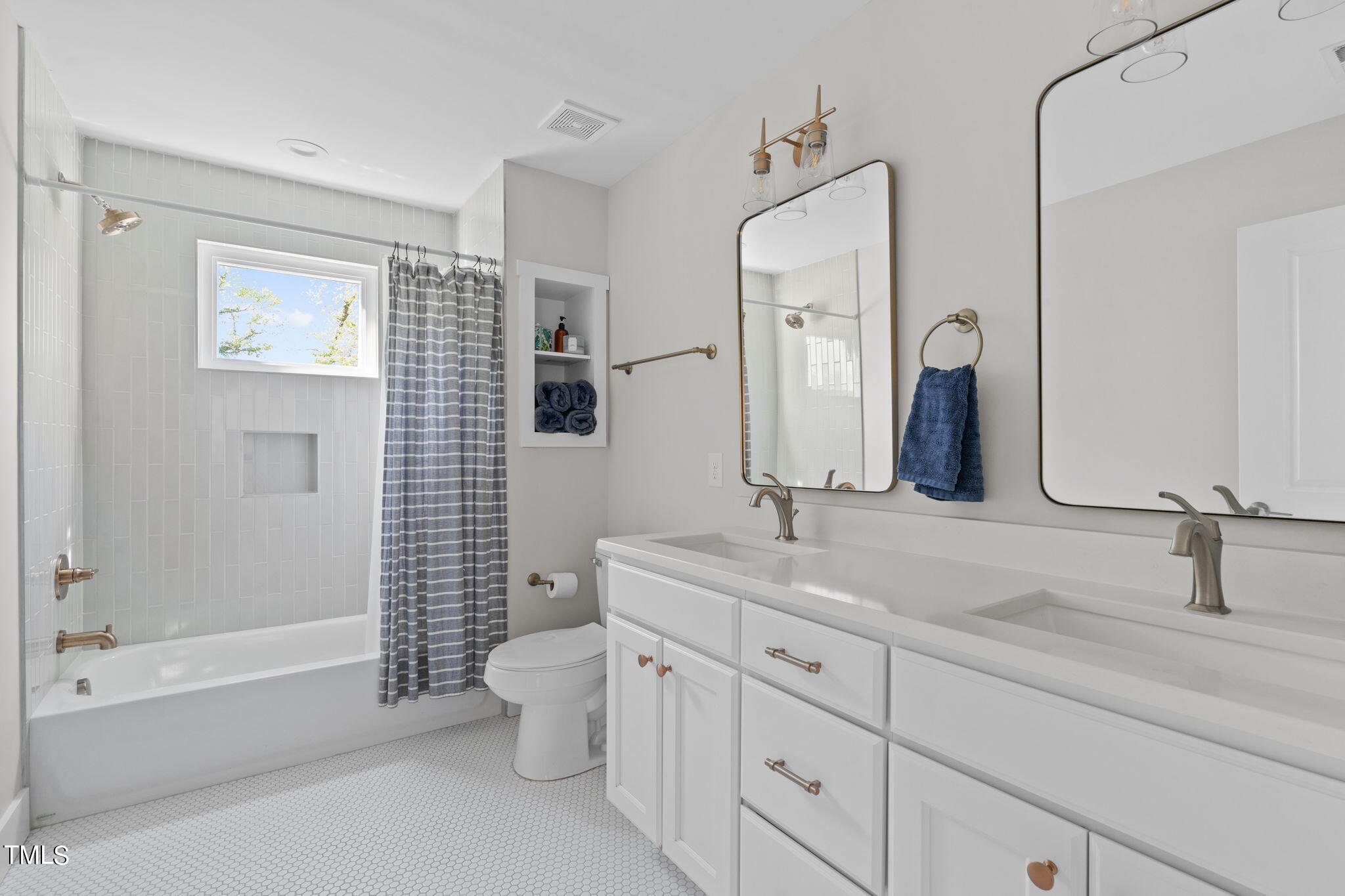 312 East Lee Street Raleigh, NC 27601 - Photo 38 of 48 a bathroom with a double vanity sink toilet mirror and shower