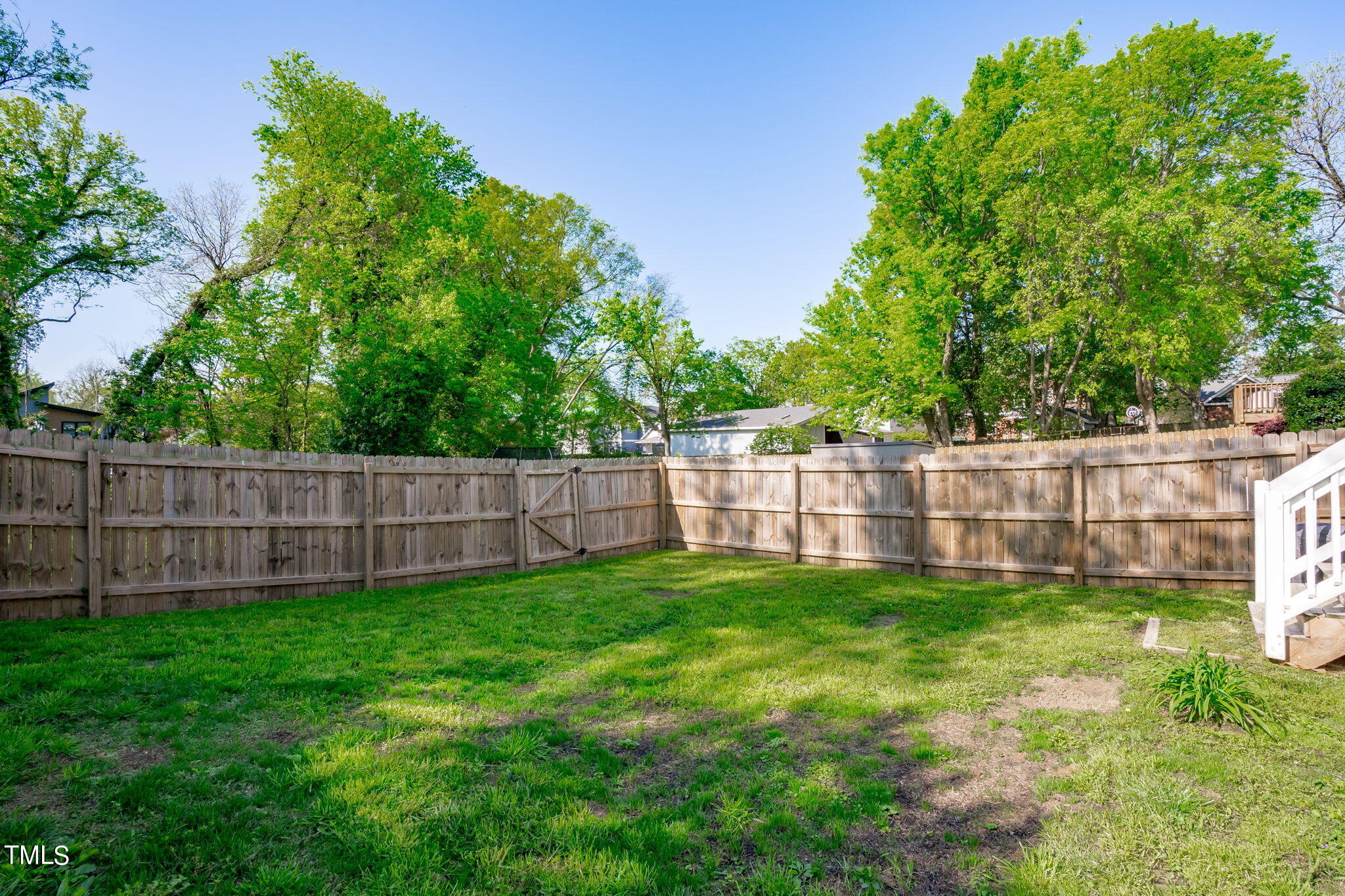 312 East Lee Street Raleigh, NC 27601 - Photo 44 of 48 a view of a yard with a small trees and wooden fence