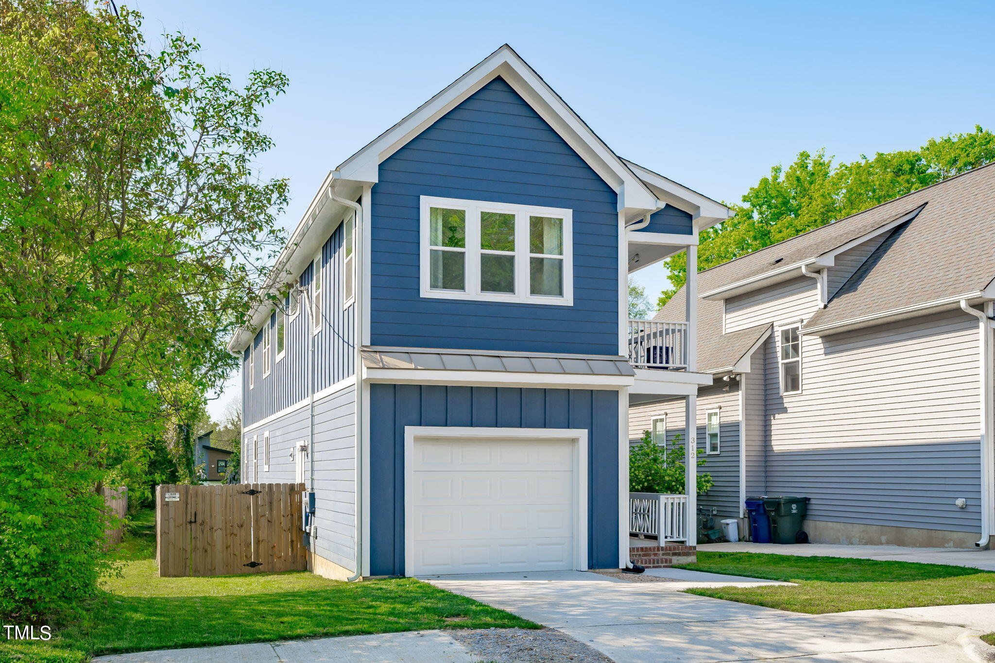 312 East Lee Street Raleigh, NC 27601 - Photo 47 of 48 a front view of a house with a garden and garage