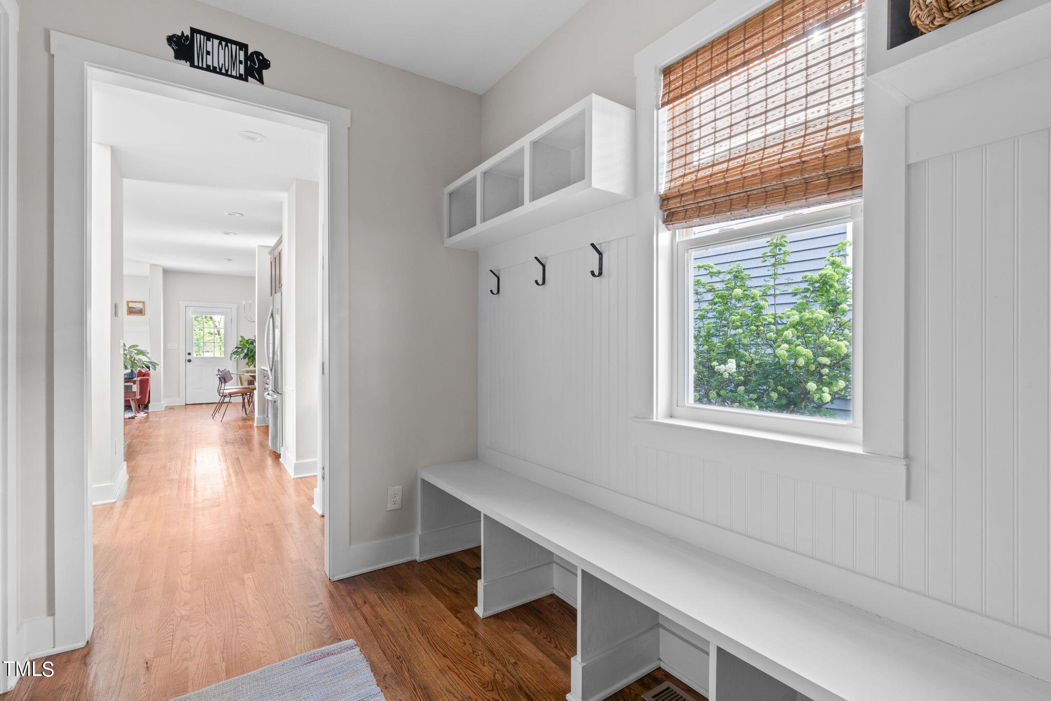 312 East Lee Street Raleigh, NC 27601 - Photo 7 of 48 a hallway with a wooden floor and a dining table