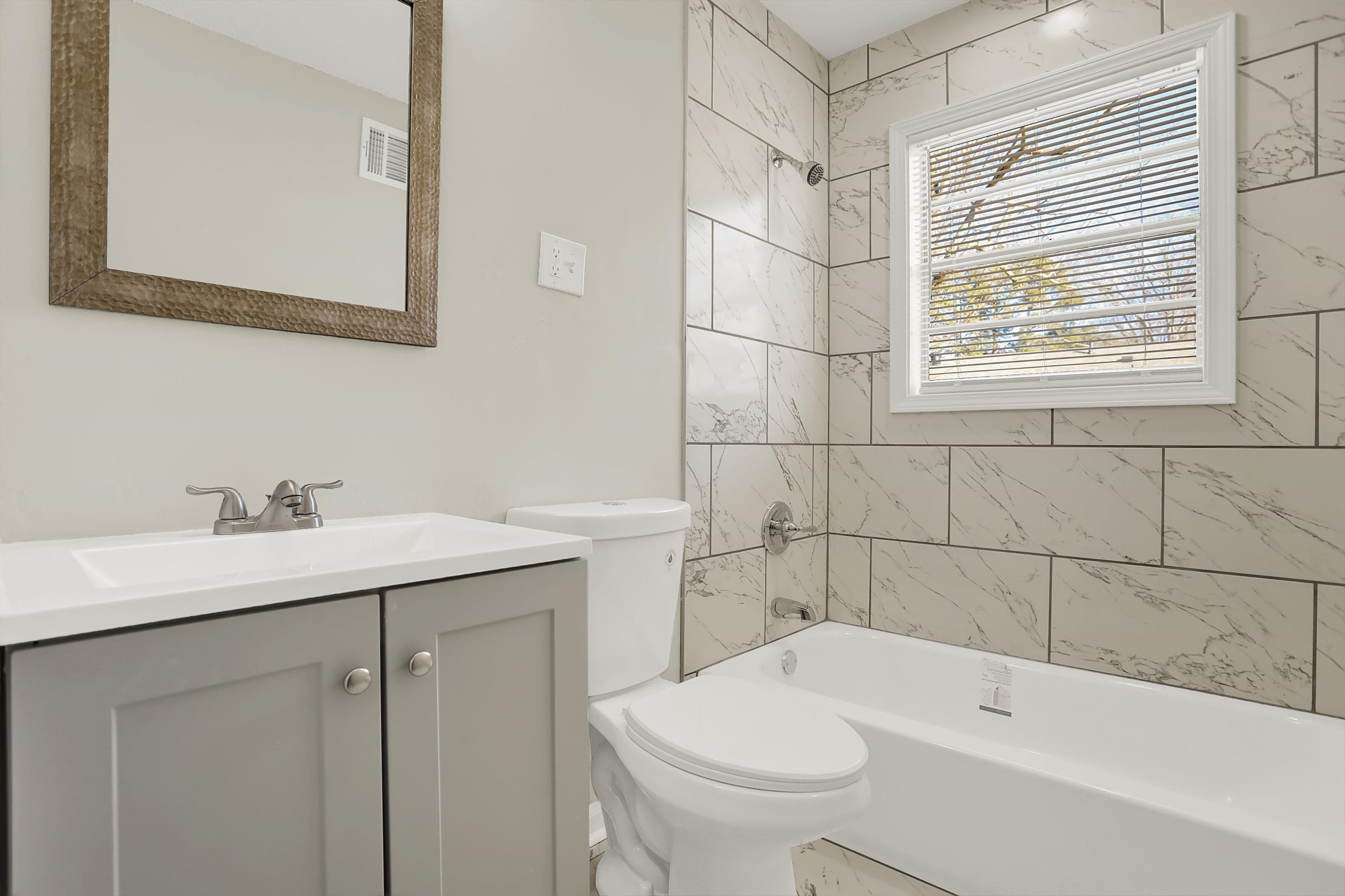 3716 Ridgemont Road Memphis, TN 38128 - Photo 15 of 30 a bathroom with a sink a toilet and shower