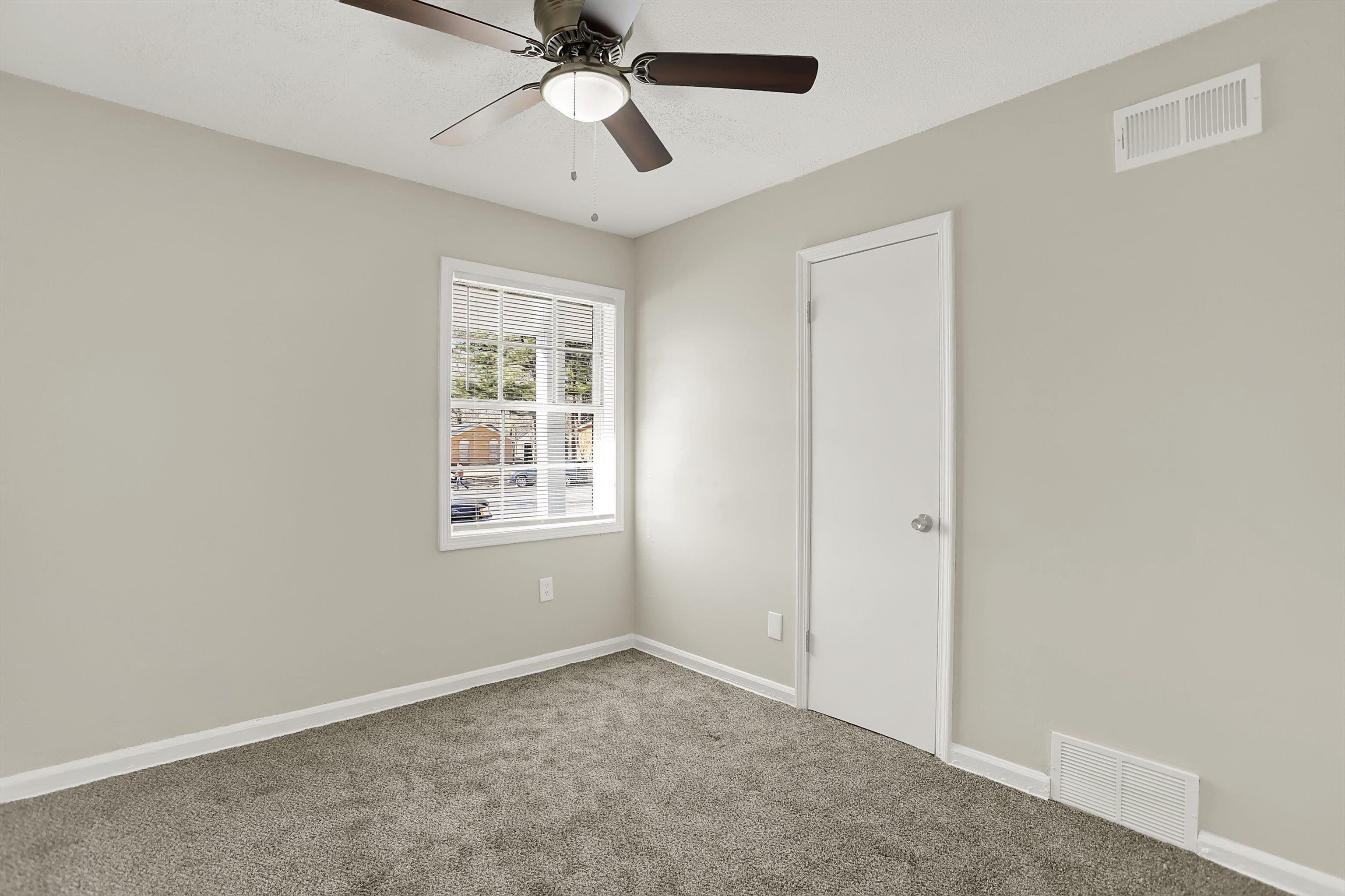 3716 Ridgemont Road Memphis, TN 38128 - Photo 16 of 30 an empty room with a window and a fan