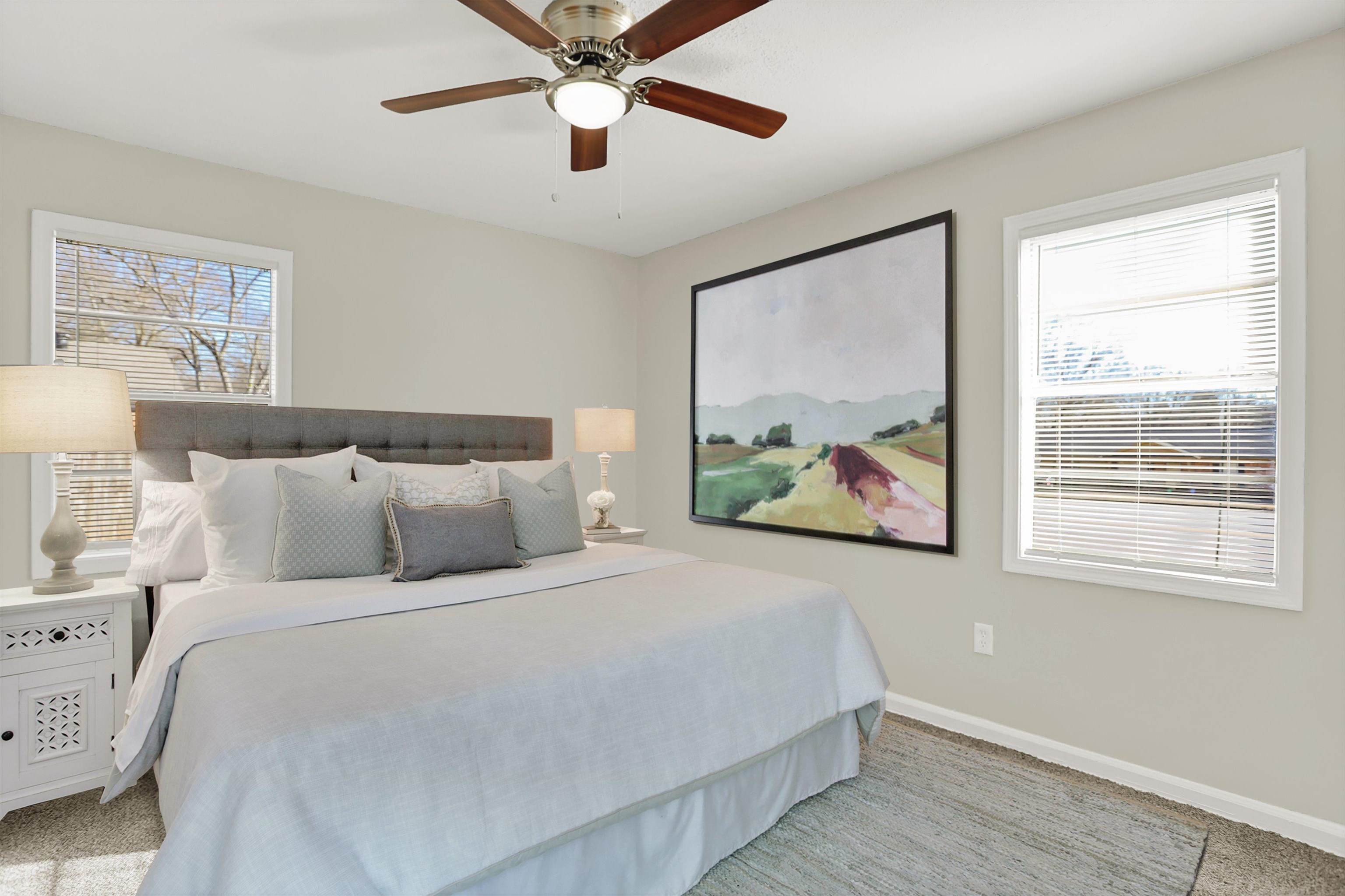 3716 Ridgemont Road Memphis, TN 38128 - Photo 24 of 30 a bedroom with a large bed and a painting on the wall