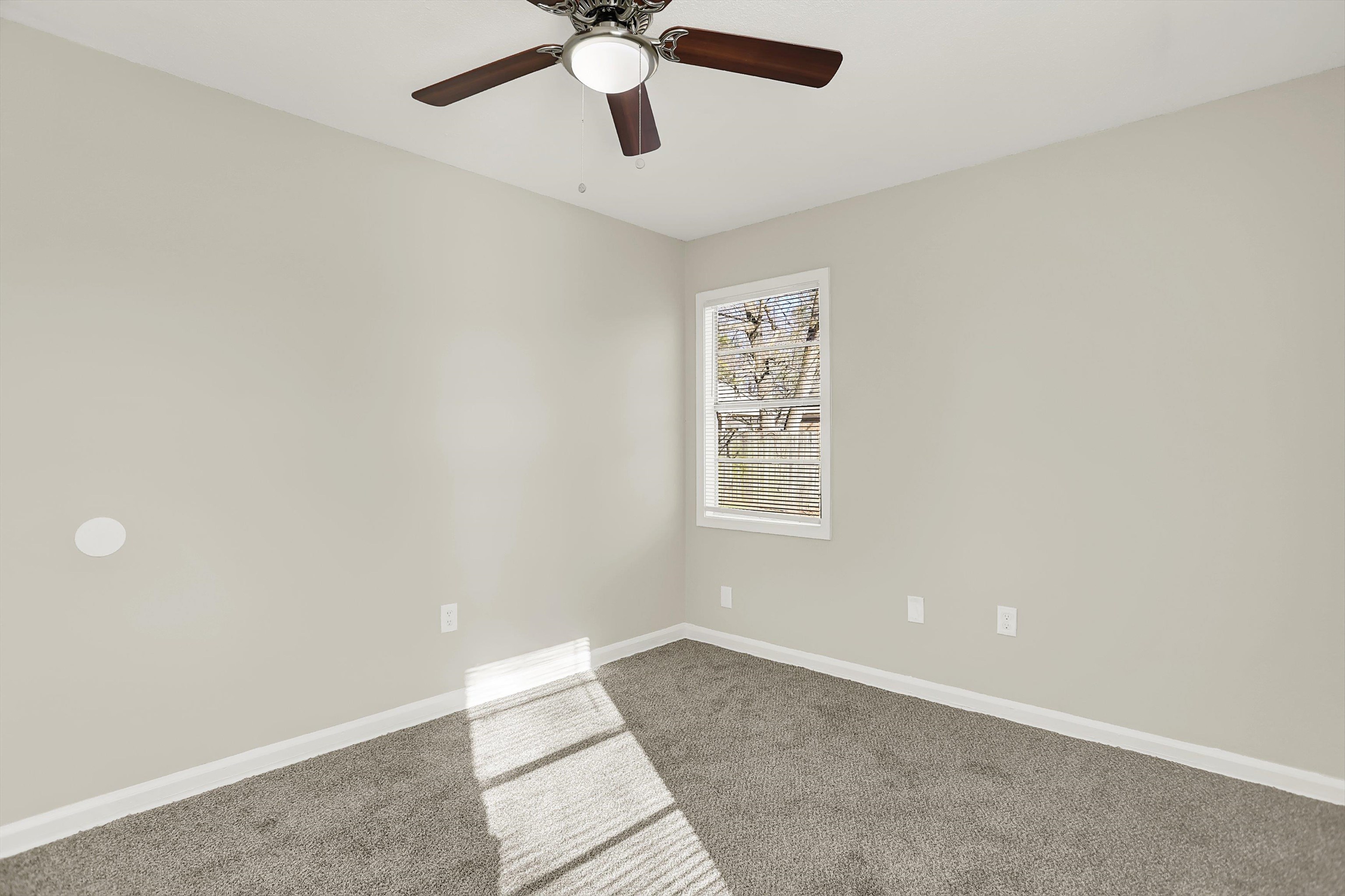 3716 Ridgemont Road Memphis, TN 38128 - Photo 27 of 30 an empty room with windows and fan