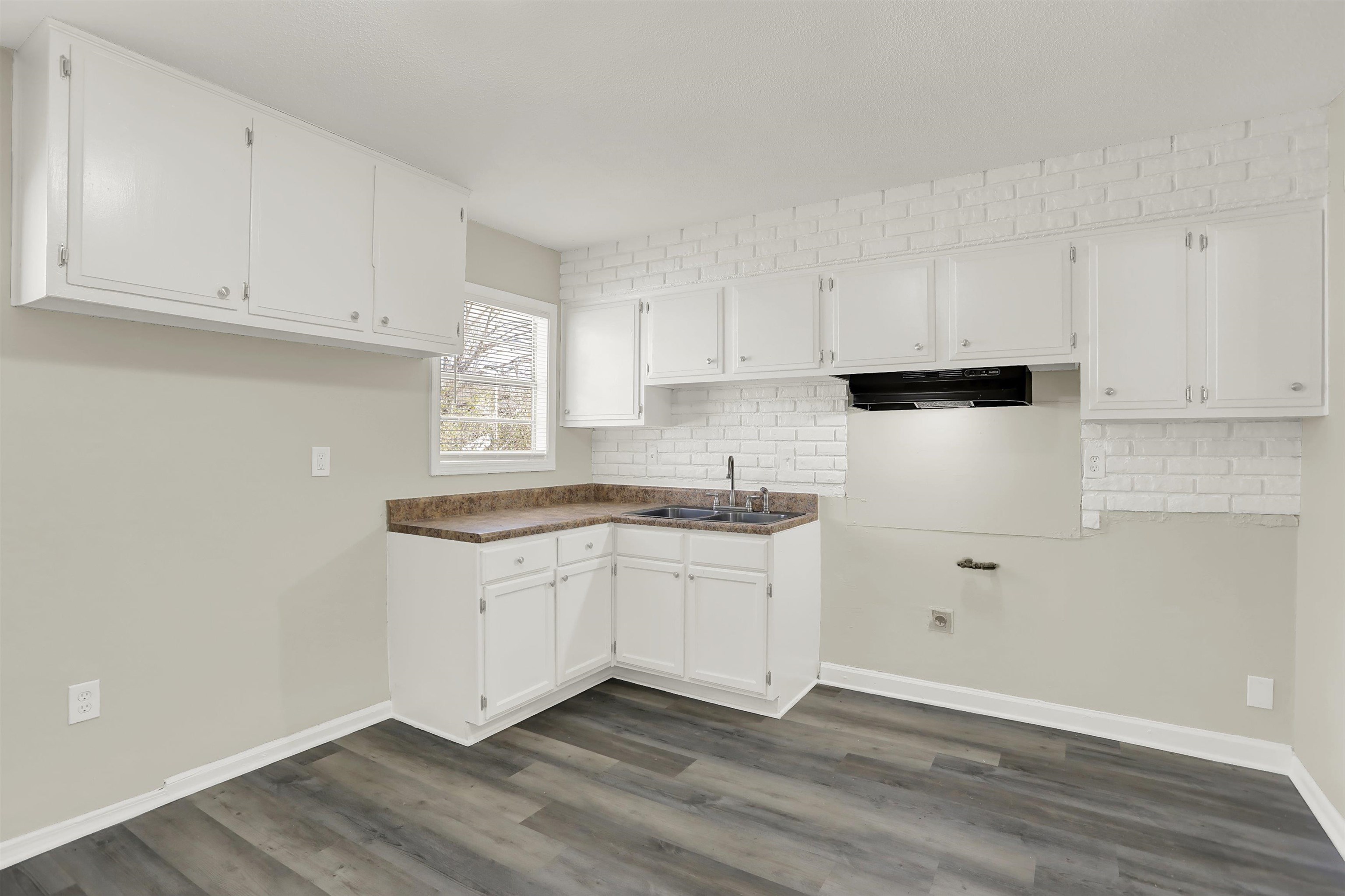 3716 Ridgemont Road Memphis, TN 38128 - Photo 7 of 30 a kitchen with granite countertop white cabinets and white appliances