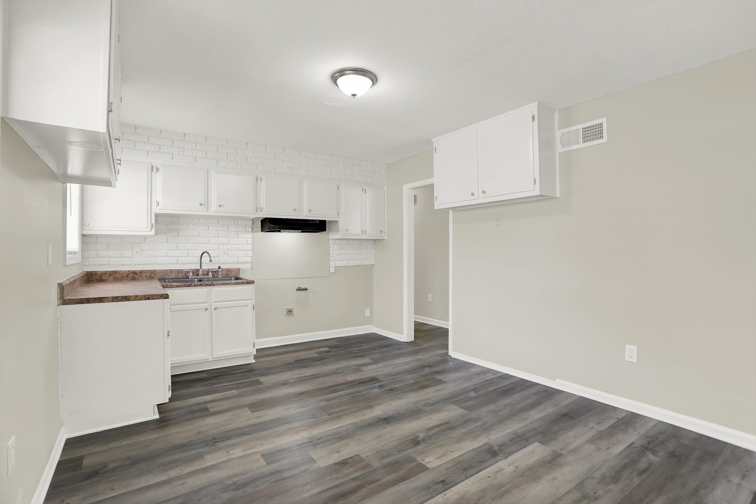 3716 Ridgemont Road Memphis, TN 38128 - Photo 9 of 30 a kitchen with granite countertop white cabinets and white appliances