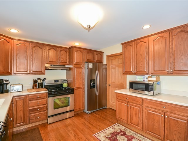 312 Main Street Oswego, IL 60543 - Photo 13 of 29 a kitchen with stainless steel appliances granite countertop a refrigerator stove and sink