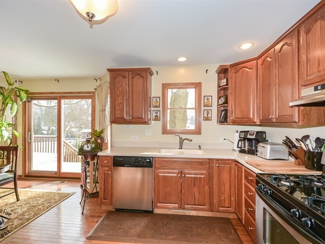312 Main Street Oswego, IL 60543 - Photo 14 of 29 a kitchen with a sink stove and cabinets